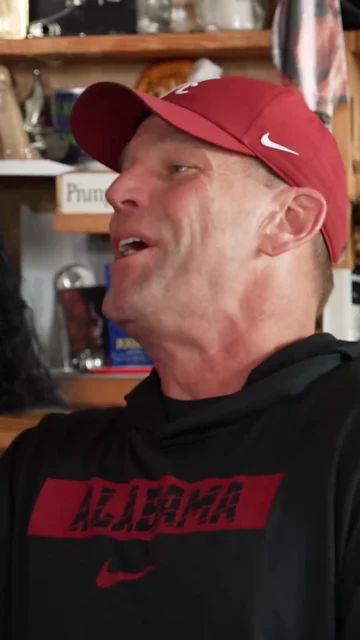 Reference lead singer wearing a red cap in the coaches parody