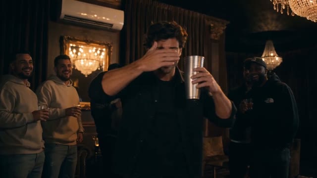 Lead performer covers his eyes with one hand while holding the cup