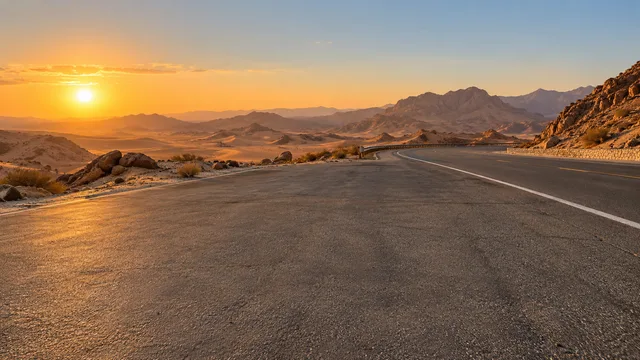 Open desert, mountains and a golden sky.